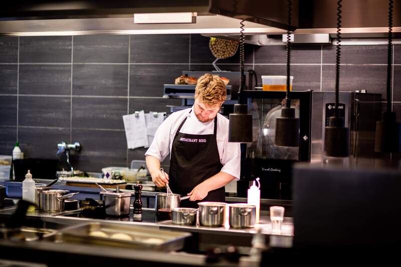 Chef whisking sauces in a commercial kitchen located in Hollywood