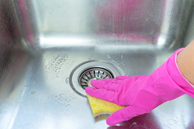 sink getting cleaned with sponge